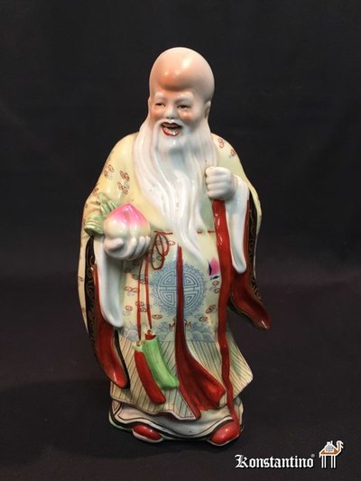 1083-C  26 cms   Figura en porcelana policromada de anciano sabio chino de 1ºs del XX